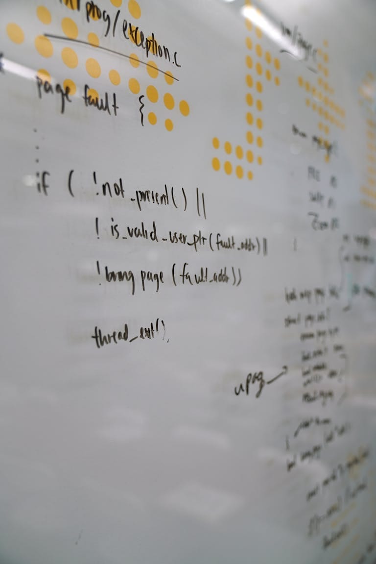 Detailed view of handwritten code on a white board, perfect for tech presentations and lectures.